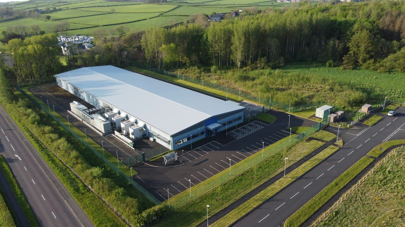 Aerial view of a purpose-built data center with its cooling plant alongside the building