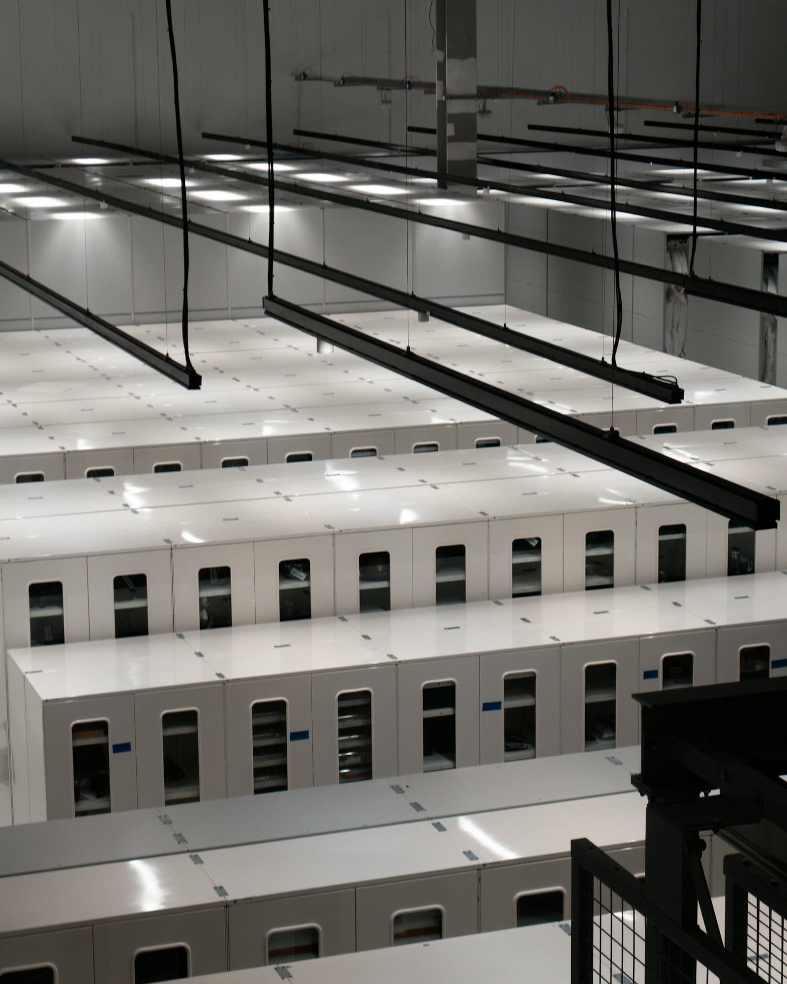 Modern data hall with rows of white server cabinets